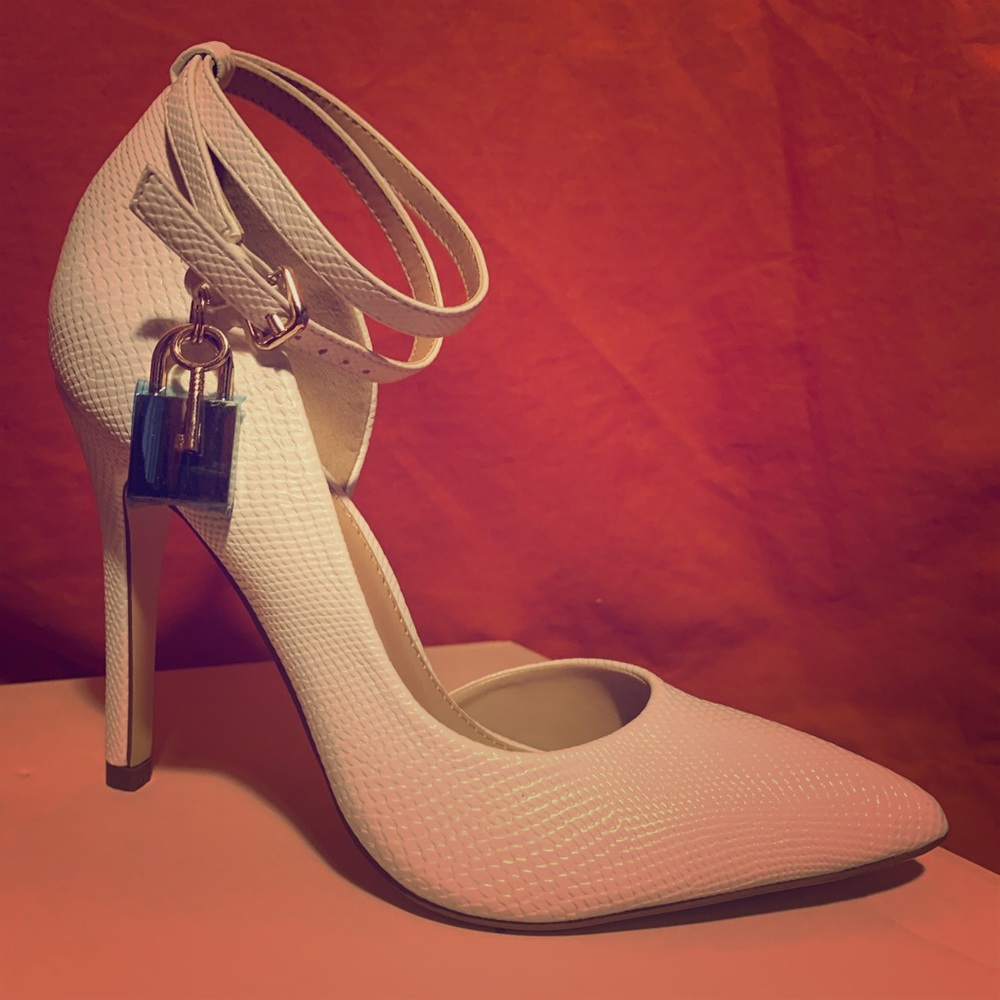 White closed toe heels with lock charm on the side
